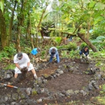 Volunteers build a dry stream bed in the Agro-forest.